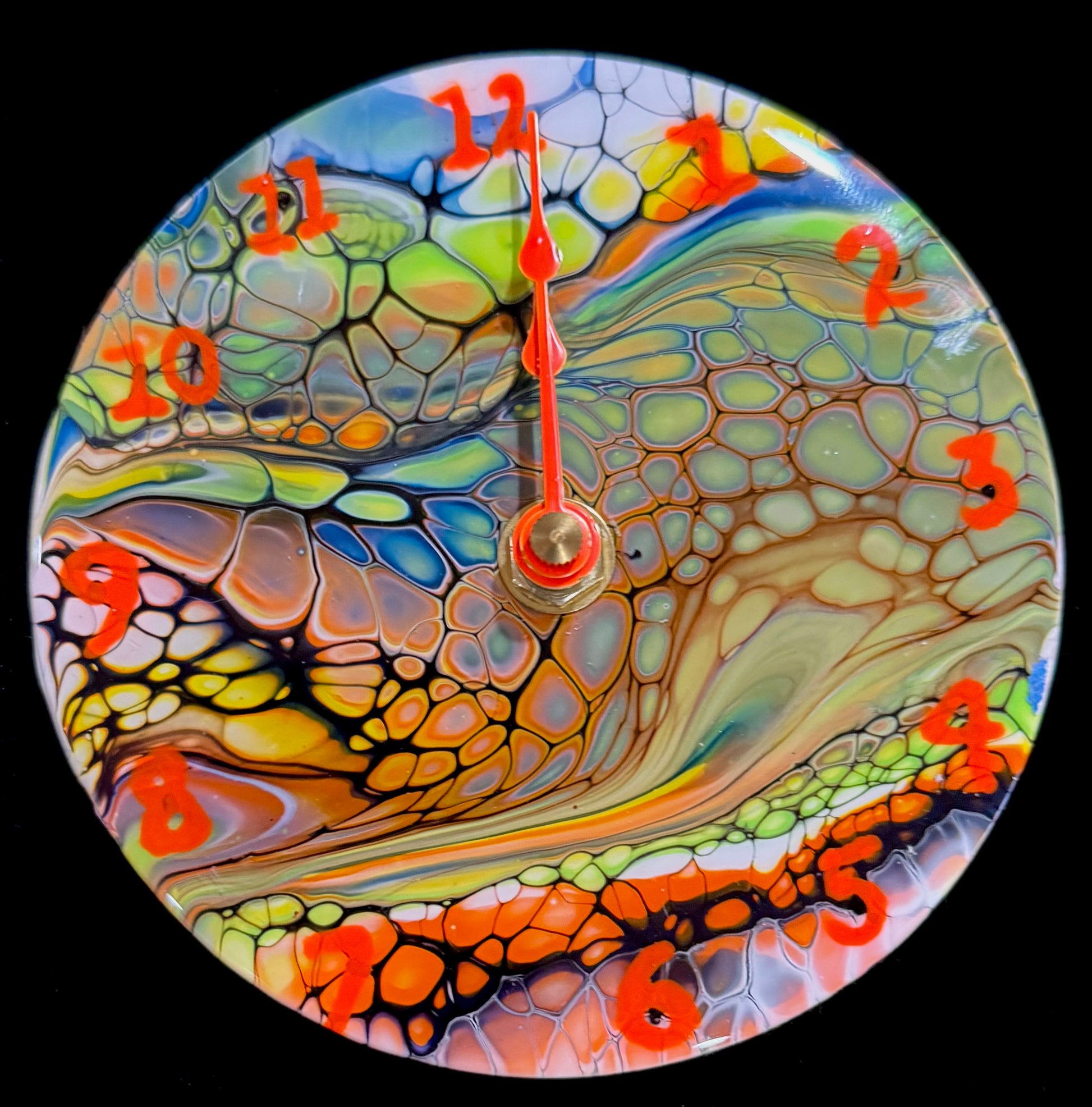 Small clocks created using DVDs.  The clocks are painted with acrylic paint using the Bloom process.  After decorating in a specific theme, the clock is coated with high quality resin.  The clocks are colorful and great for any person.