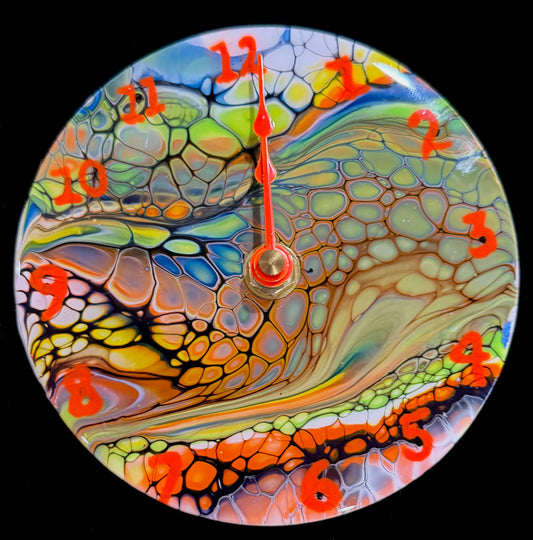 Small clocks created using DVDs.  The clocks are painted with acrylic paint using the Bloom process.  After decorating in a specific theme, the clock is coated with high quality resin.  The clocks are colorful and great for any person.